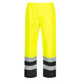 High-visibility yellow work pants with reflective stripes, black at ankles on a white background