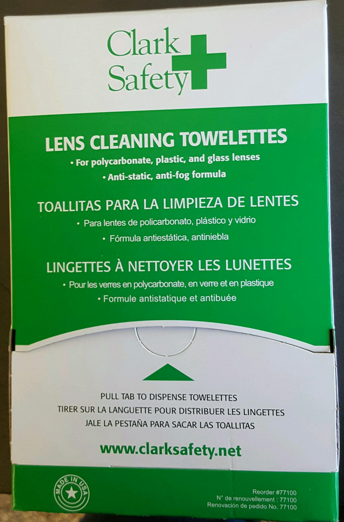 Box of Clark Safety lens cleaning towelettes with green and white packaging, detailing product use for plastic, glass, and polycarbonate lenses.
